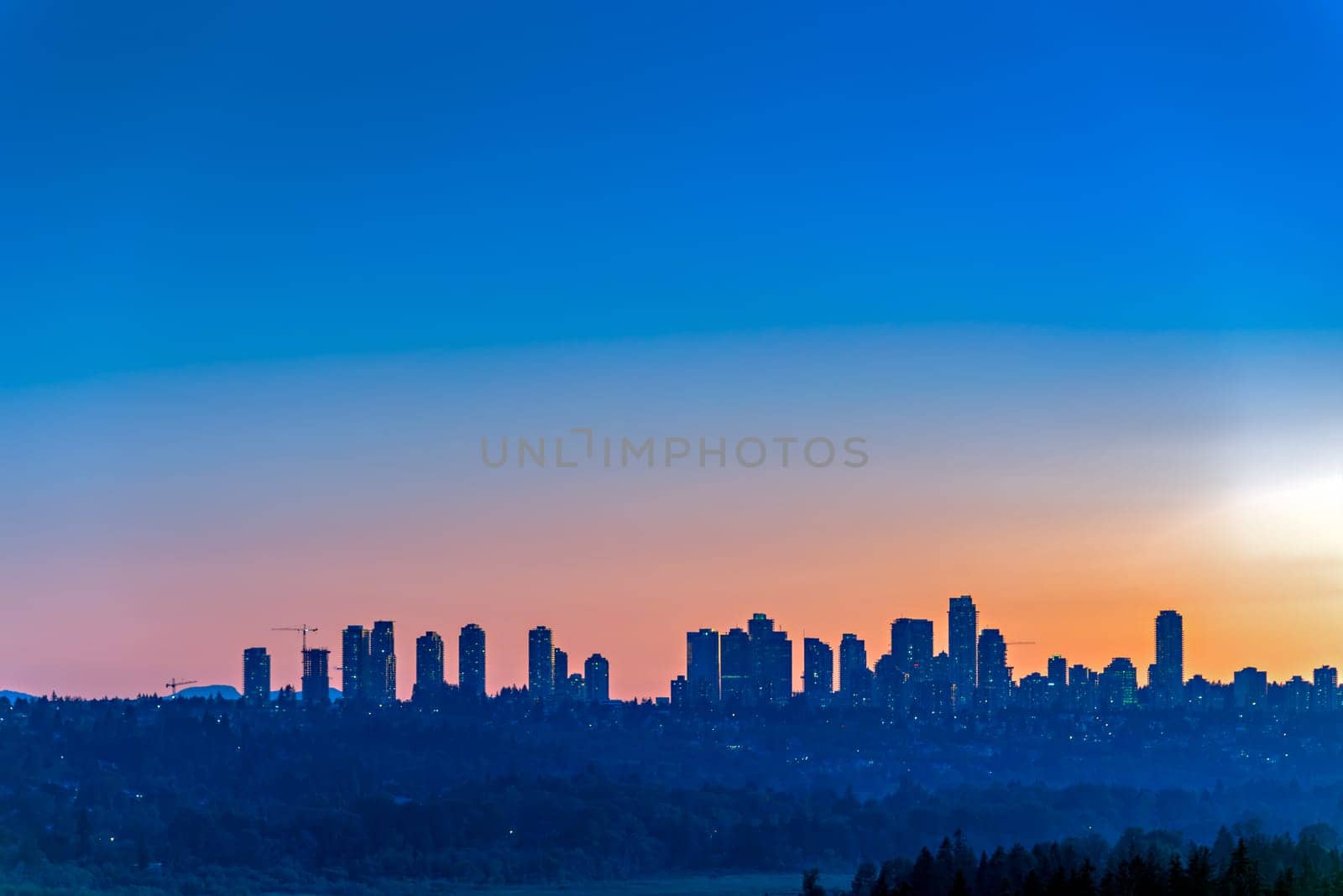 Metrotown district on sunset sky background.