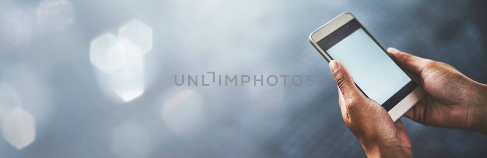 Person, hands and phone screen on mockup for social media, communication or networking on banner. Closeup of user with mobile smartphone app, display or advertising technology on bokeh background by YuriArcurs