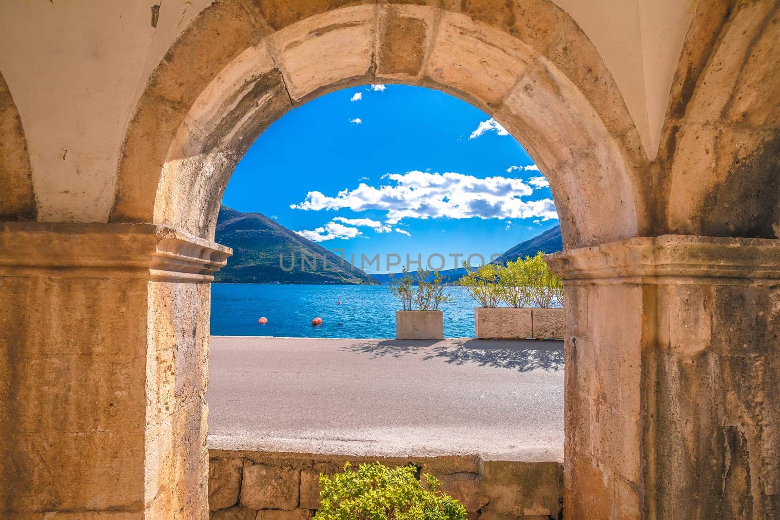 Kotor bay landscape through historic architecture arch, archipelago of Montenegro