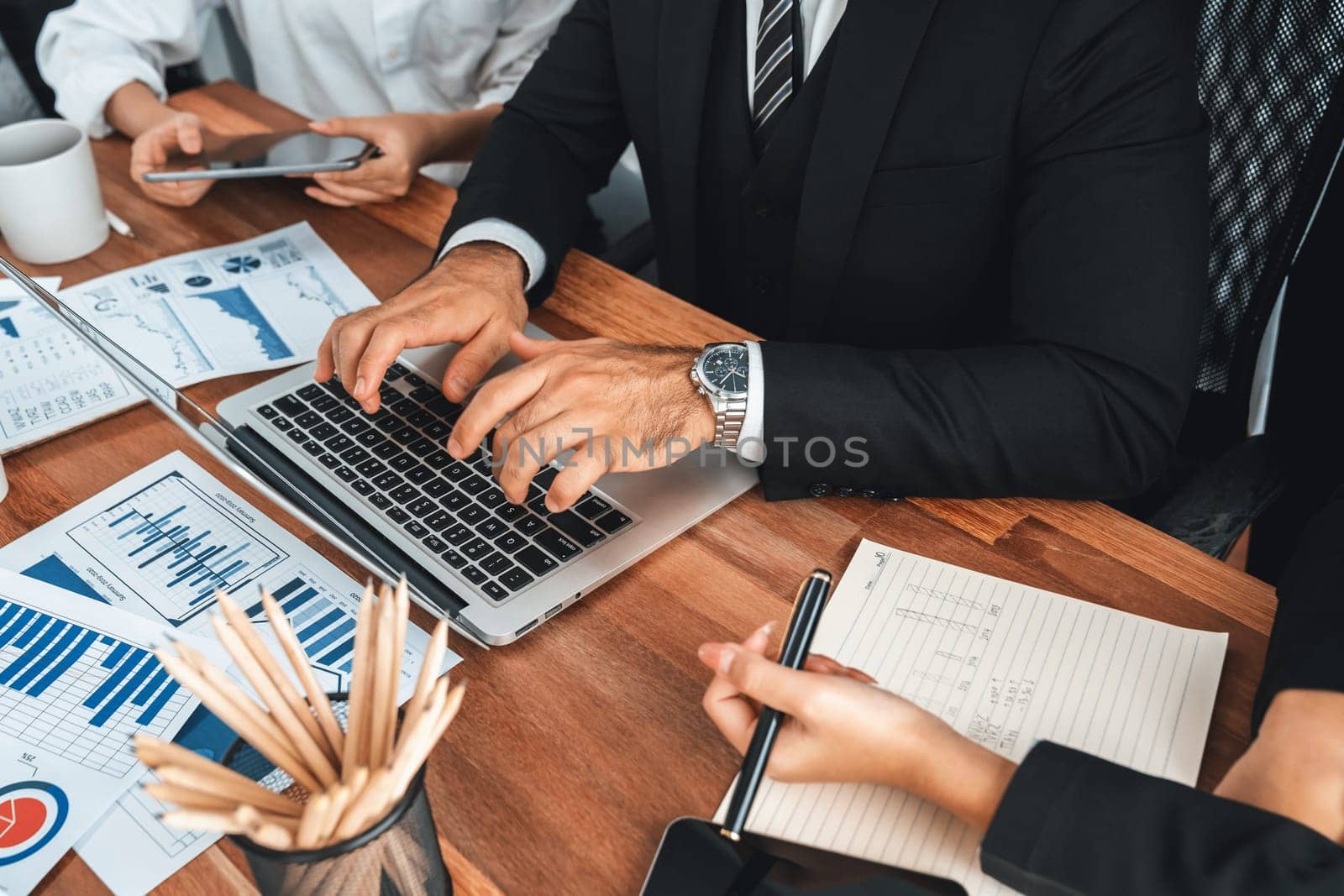 Diverse group of business analyst team analyzing financial data report paper on office table. Chart and graph dashboard by business intelligence analysis for strategic marketing planning Meticulous