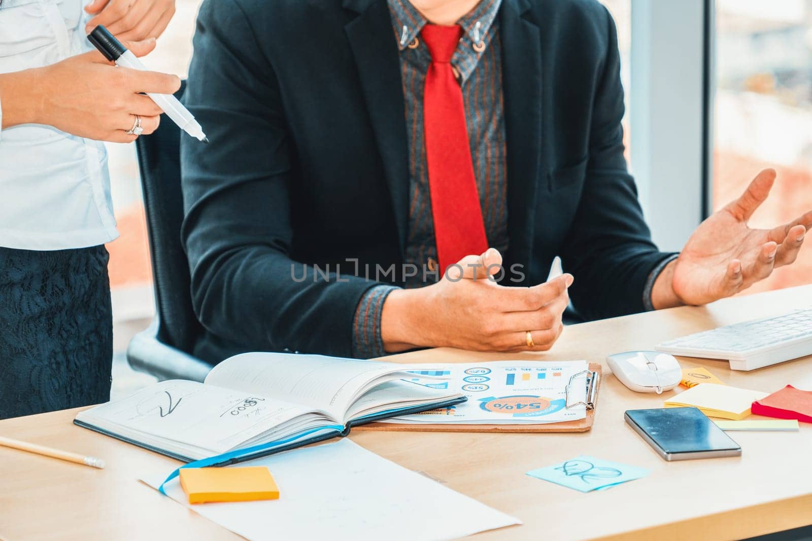 Two business people talk project strategy at office meeting room. Businessman discuss project planning with colleague at modern workplace while having conversation and advice on financial report. Jivy