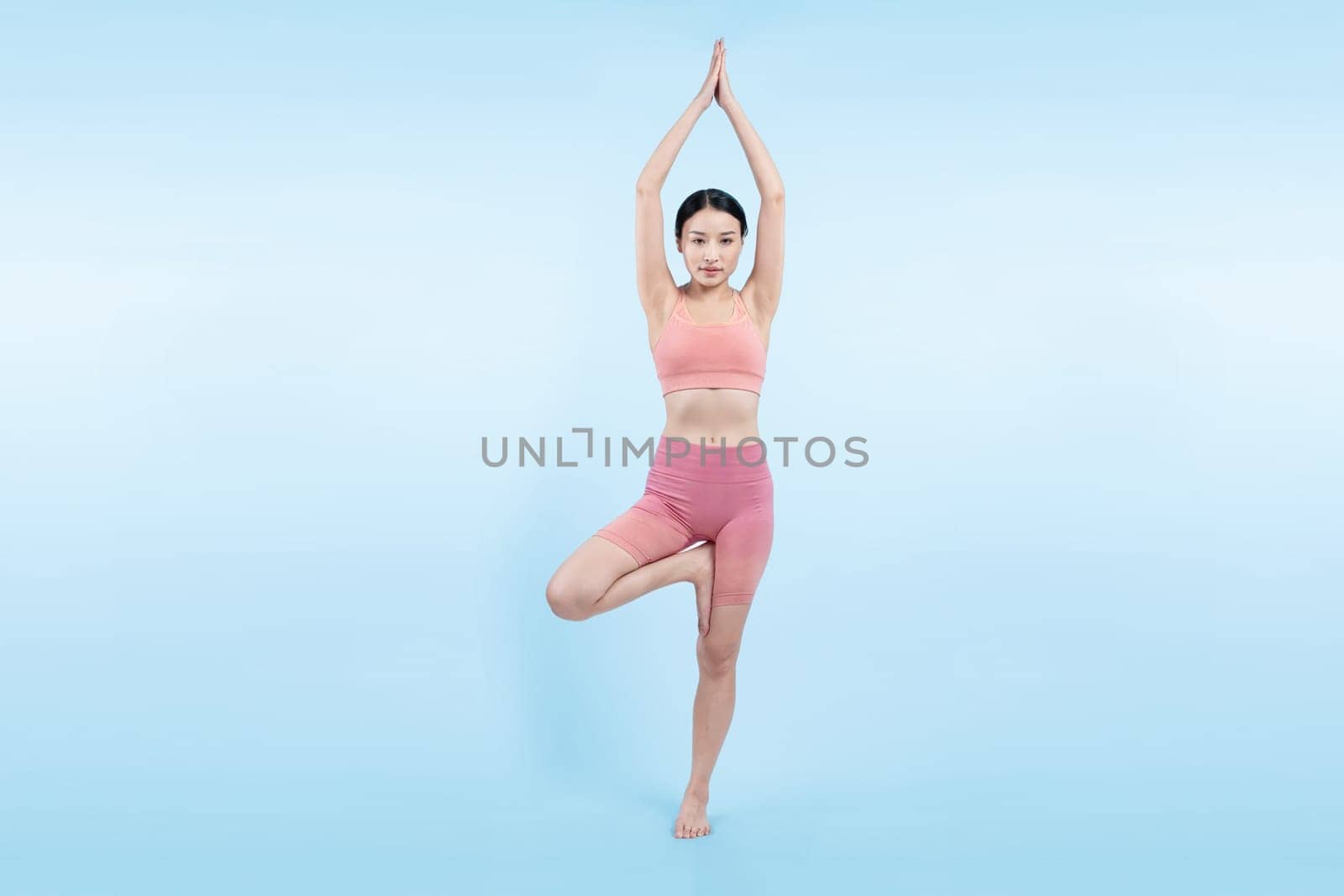 Asian woman in sportswear doing yoga exercise posing. Vigorous by biancoblue