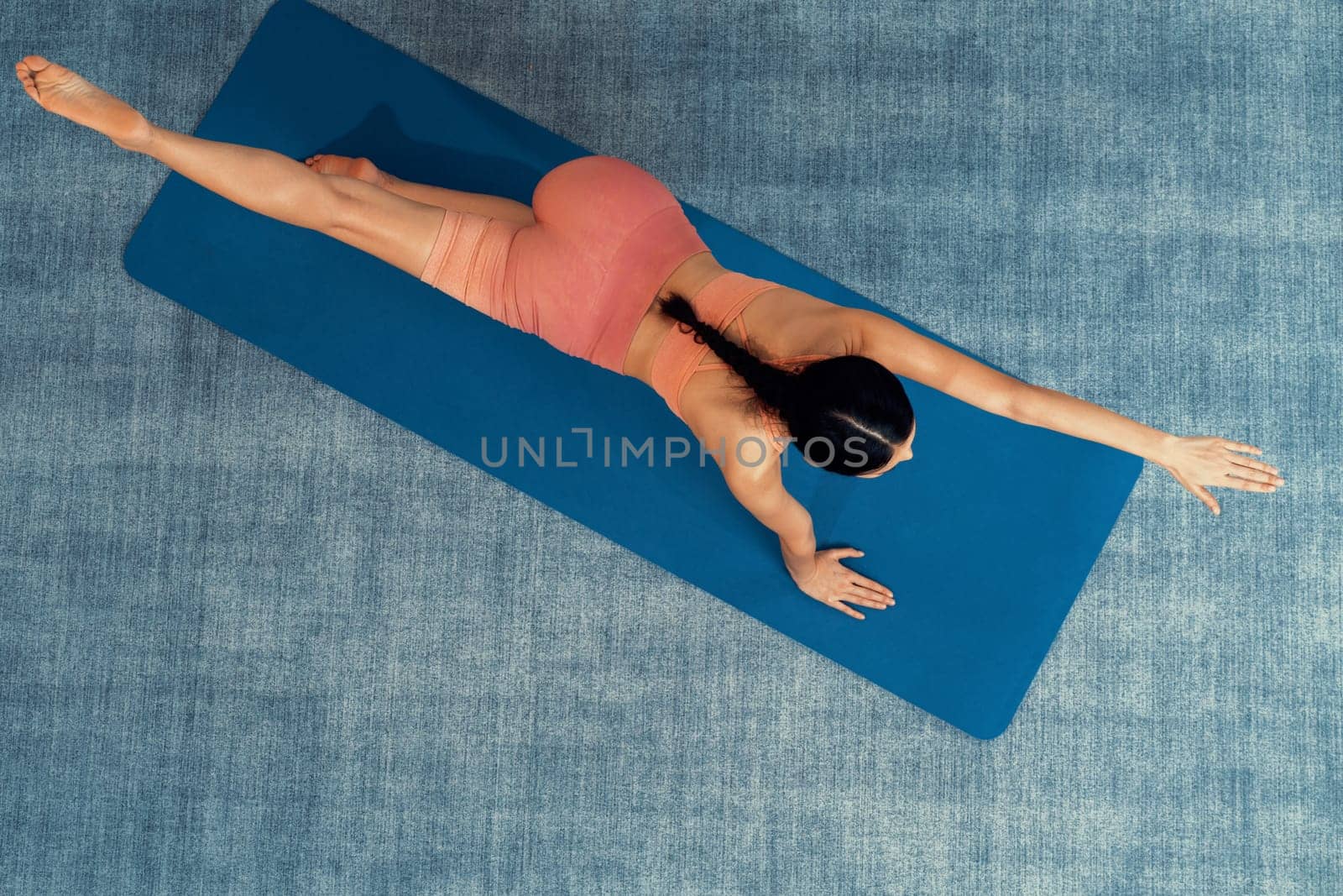 Top view asian woman in sportswear doing yoga exercise. Vigorous by biancoblue