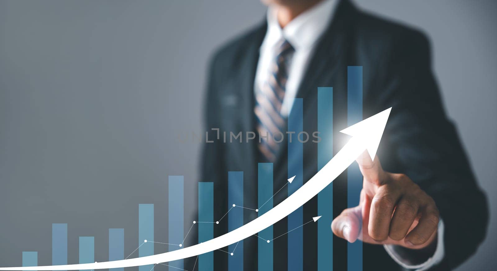 Businessman pointing arrow graph growth and financial network connection by Sorapop