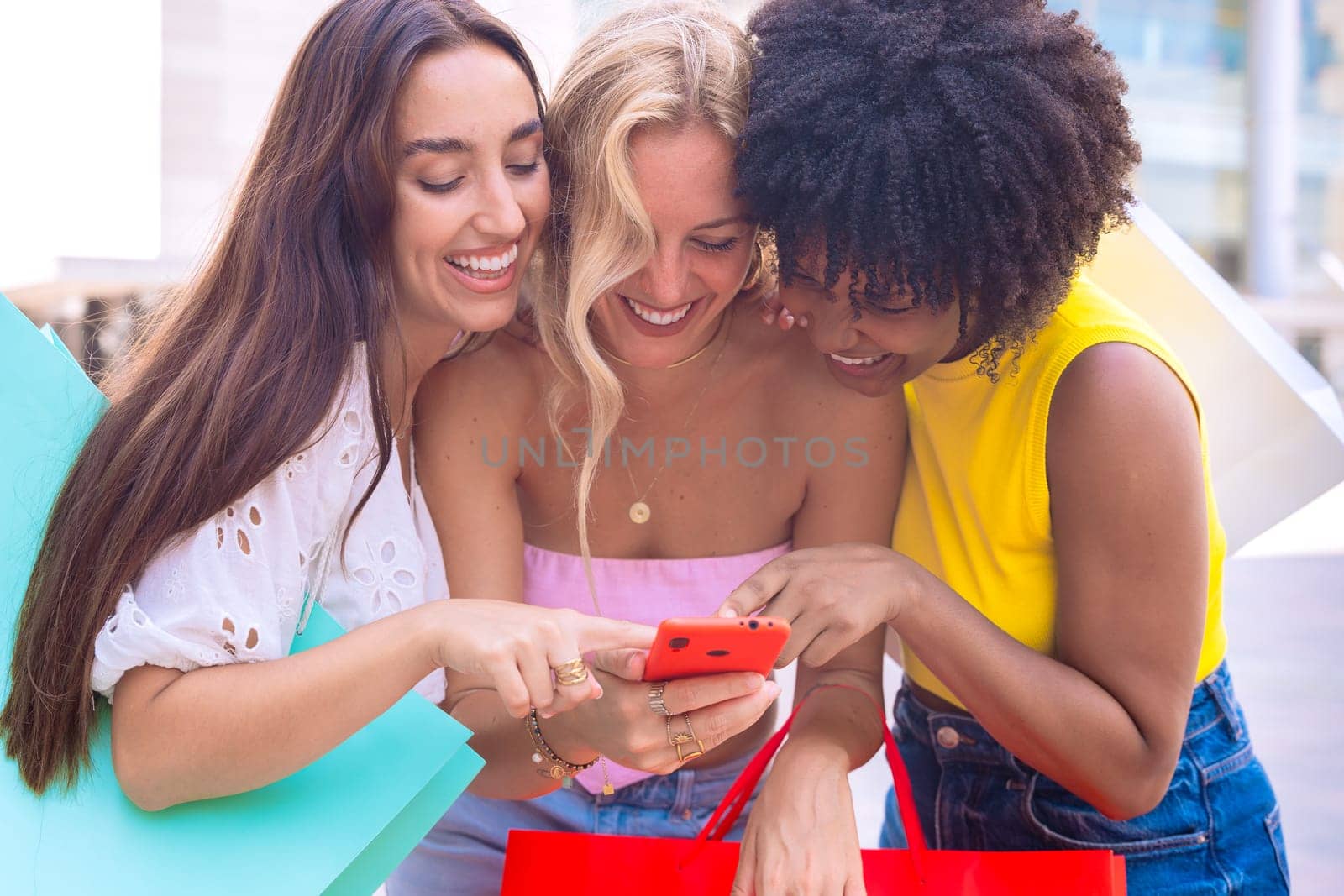 A group of three joyful women cheering and celebrating while looking at a smartphone. A vibrant and fun moment showcasing friendship, happiness, and modern connections.