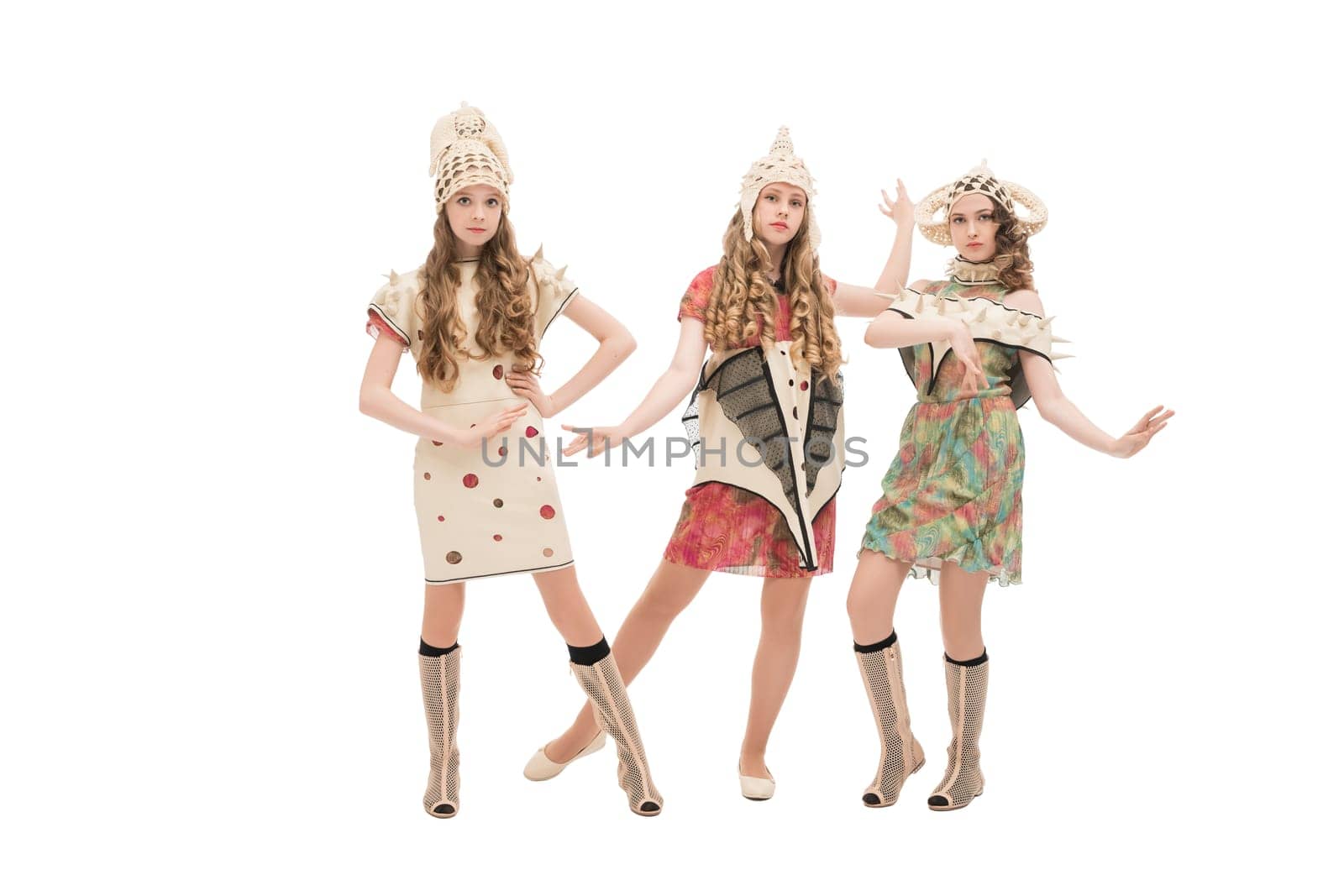 Group of pretty models wearing fashion costumes and hats isolated full-length shot
