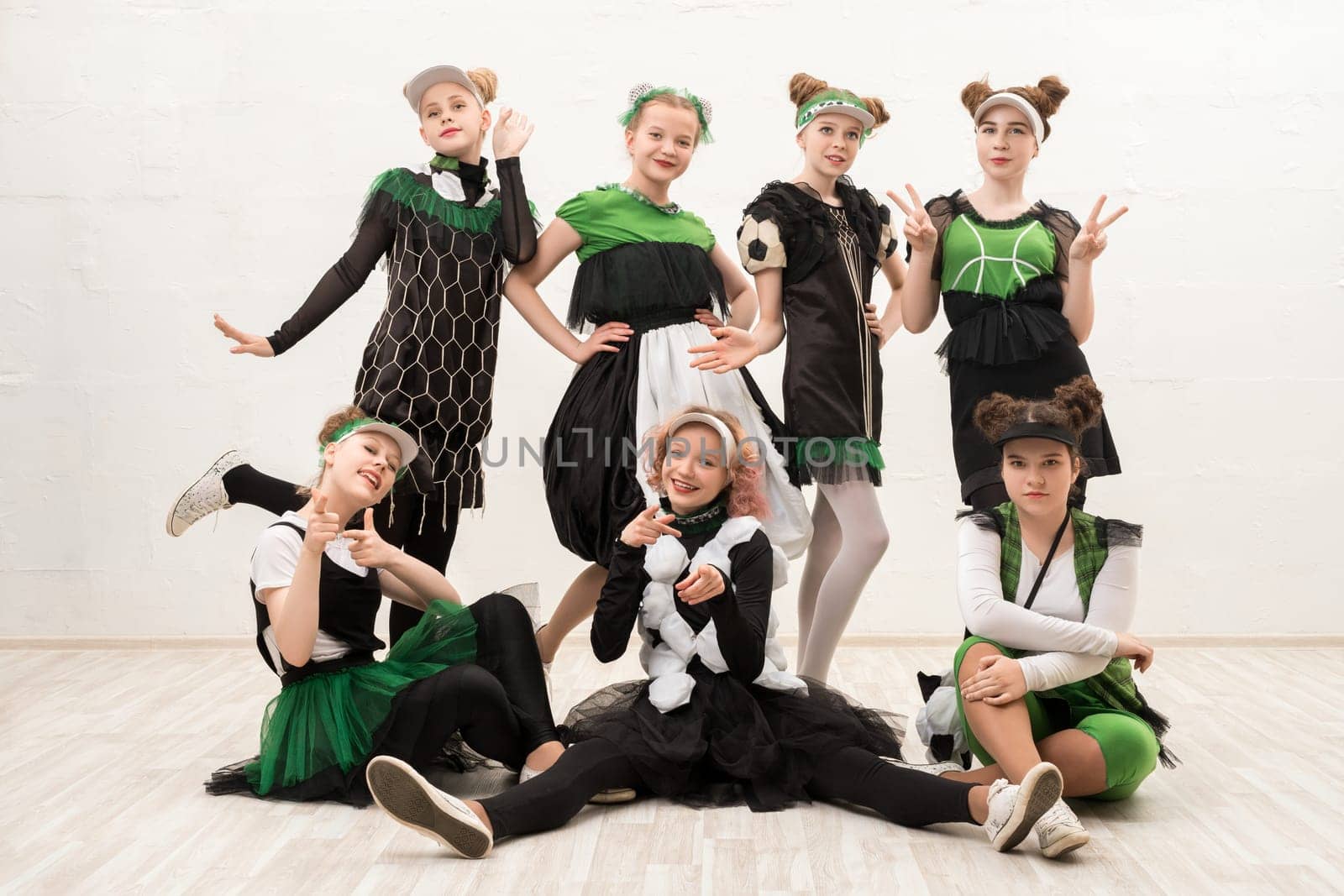 Girls wearing fashion green and black costumes isolated view