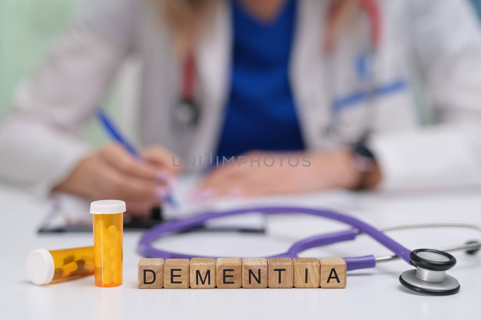 A medical professional documents the care for a dementia patient, with medication clearly visible on the table