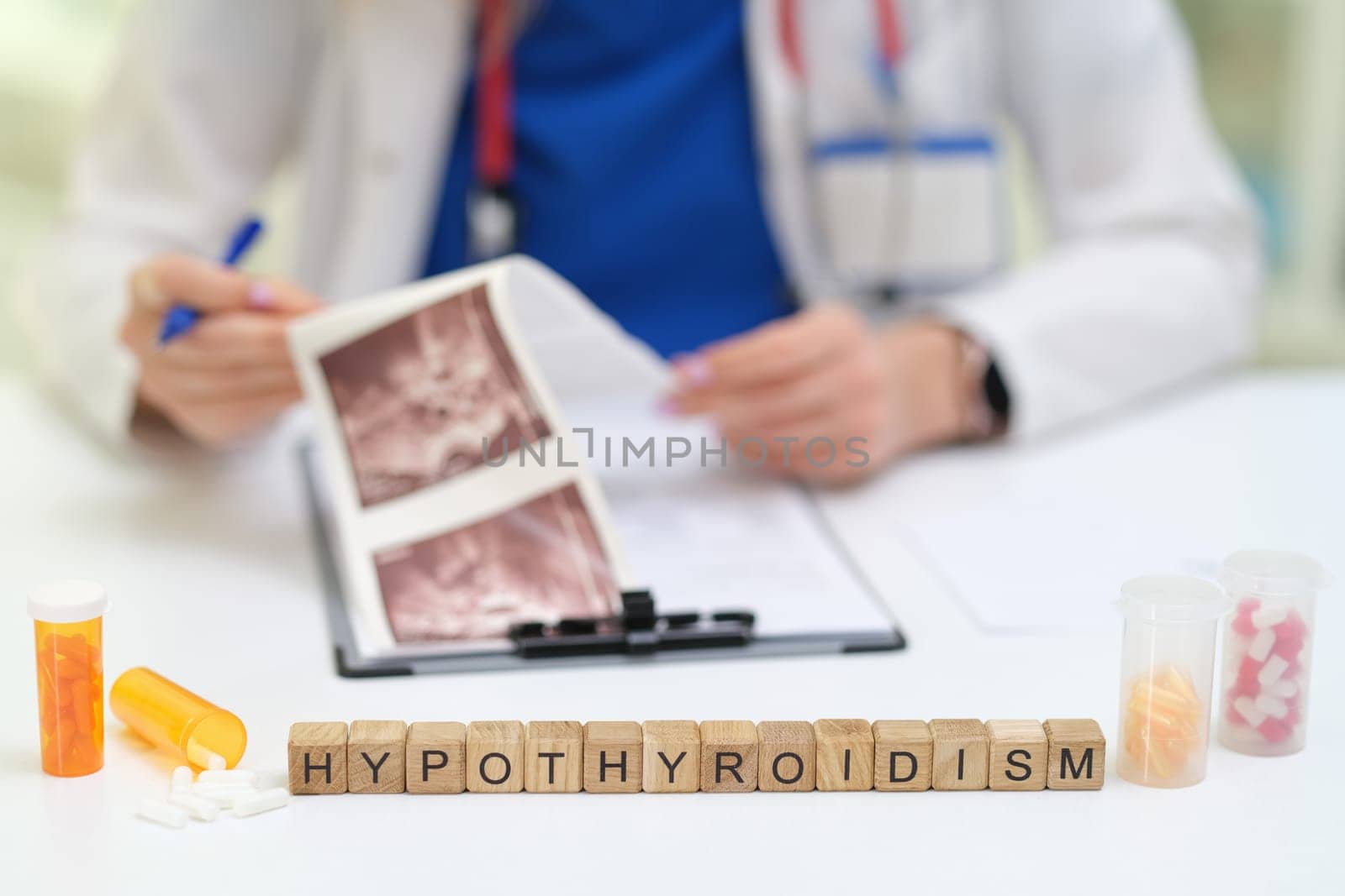 A physician is reviewing medical images linked to hypothyroidism, illustrating important health issues