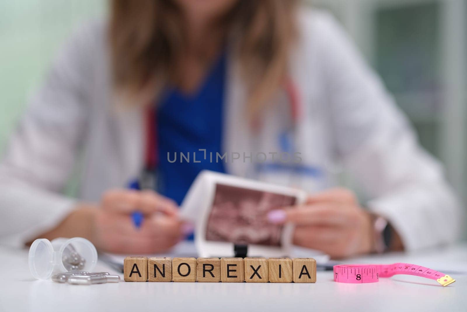 A healthcare professional carefully examines various materials and resources related to the issue of anorexia