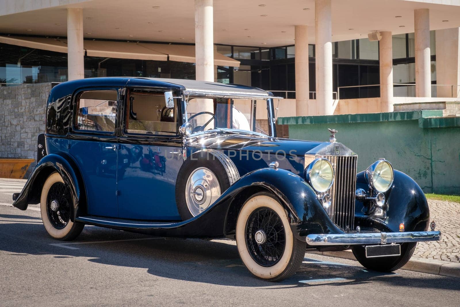 Lisbon, Portugal - Sep 29, 2024: Legendary and luxury 1937 Rolls-Royce Phantom III on sunny day in urban setting. Front grille, radiator, headlights and iconic bonnet mascot of Spirit of Ecstasy. Last car designed by Henry Royce.