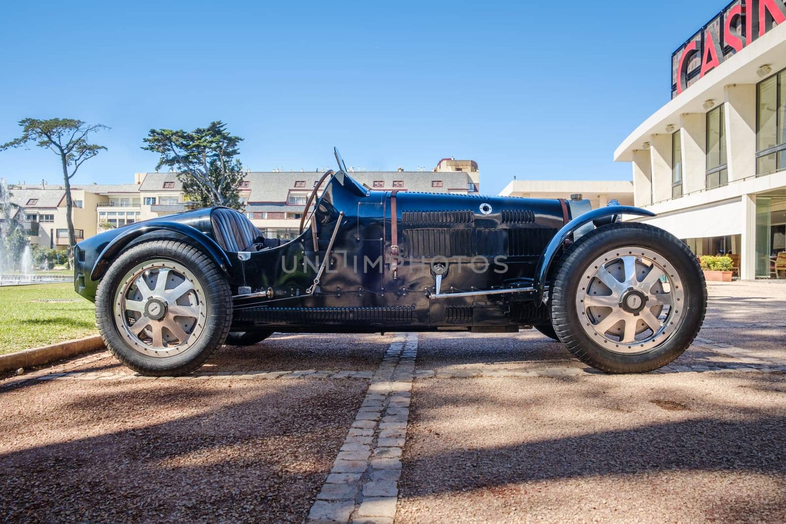 Lisbon, Portugal - Sep 29, 2024: Side view of boat tail bonnet of vintage Pur Sang Bugatti Type 35 car on sunny day. Bugatti Type 35 is race car class, Grand Prix icon of 1920s, by Bugatti, France, first car with alloy wheels.