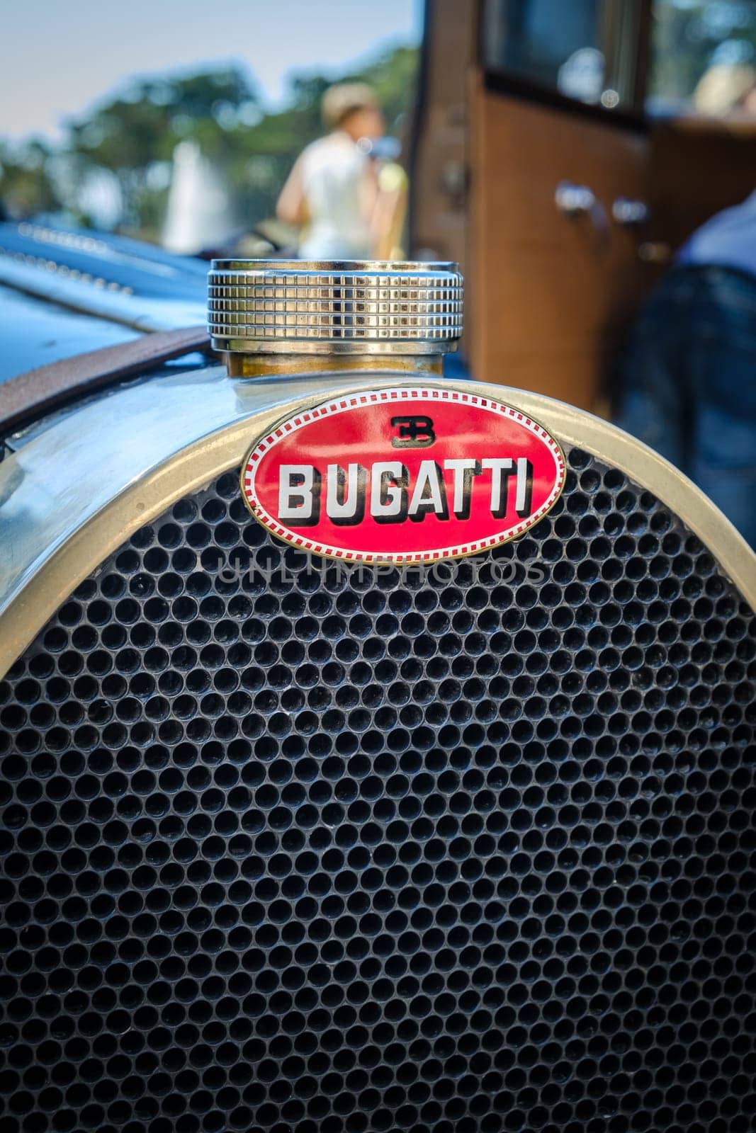 Lisbon, Portugal - Sep 29, 2024: Close view of hood and grille of original dark blue lacquered Bugatti Type 40 Grand Sport car parked in driveway near other historic car model. Grand tourer car or roadster, 1930s, by Bugatti, France.