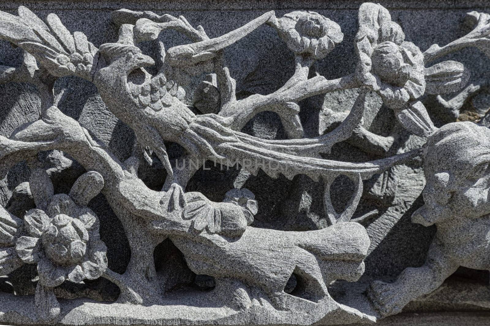 Samut Prakan, Thailand - Jan 11, 2025 - Surface texture of Stucco art in Taiwan temple. The relief on Elaborate sculptured of Stone carvings is a beautiful Taiwanese art style, use it as your Wallpaper, Poster and Space for text, Selective focus.
