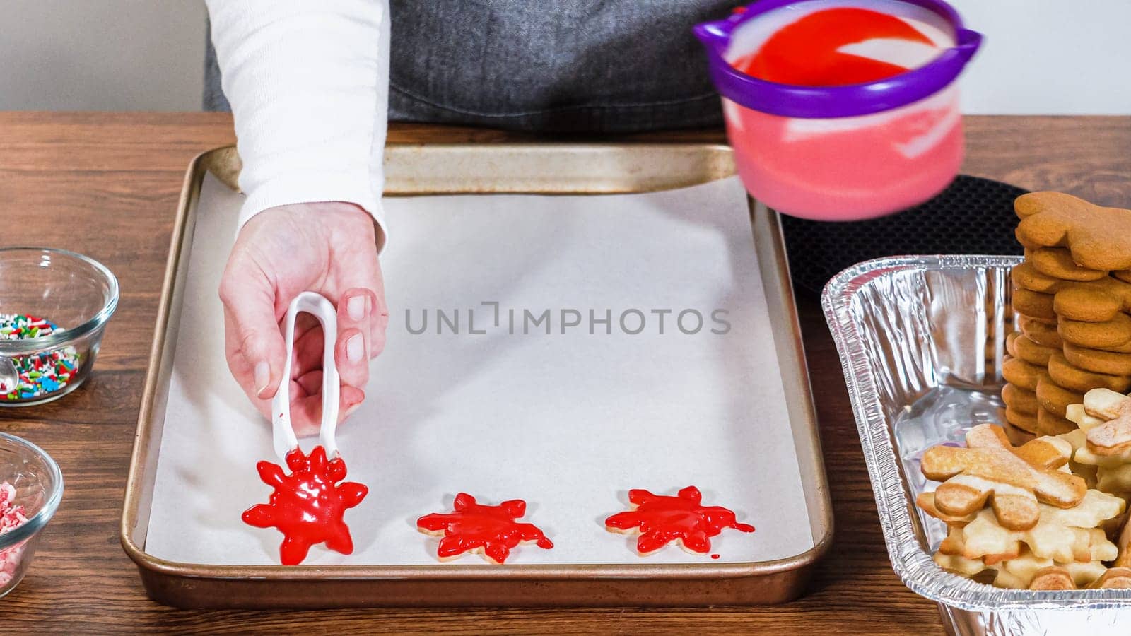 Crafting gingerbread cookie sandwiches with eggnog buttercream, presented on a rustic wooden table for Christmas gifting.