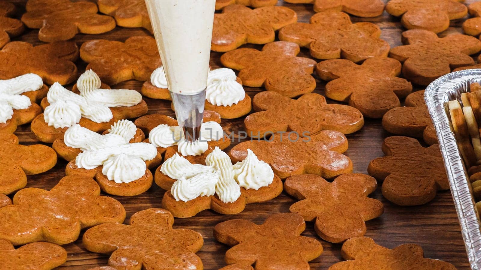 Crafting gingerbread cookie sandwiches with eggnog buttercream, presented on a rustic wooden table for Christmas gifting.
