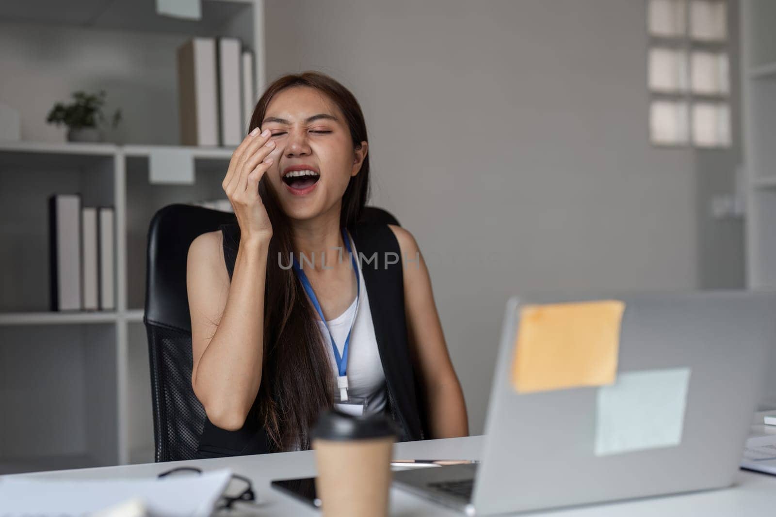 Office workers showing signs of sneezing and allergies, highlighting common workplace health issues.