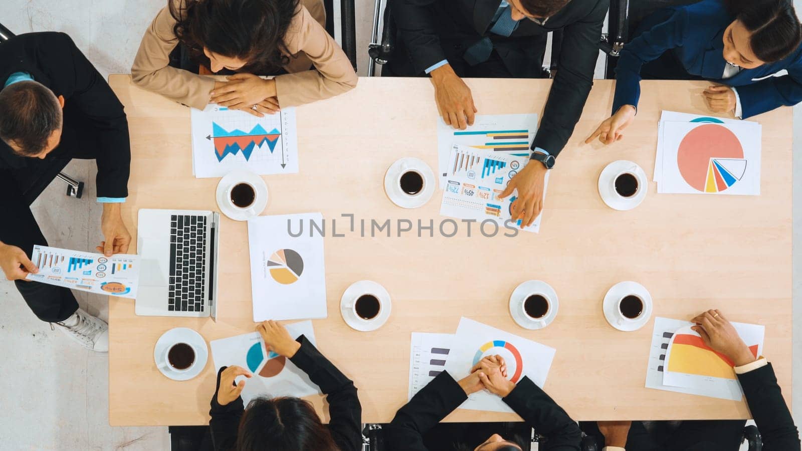 Business people group meeting shot from top view in office . Profession businesswomen, businessmen and office workers working in team conference with project planning document on meeting table . Jivy