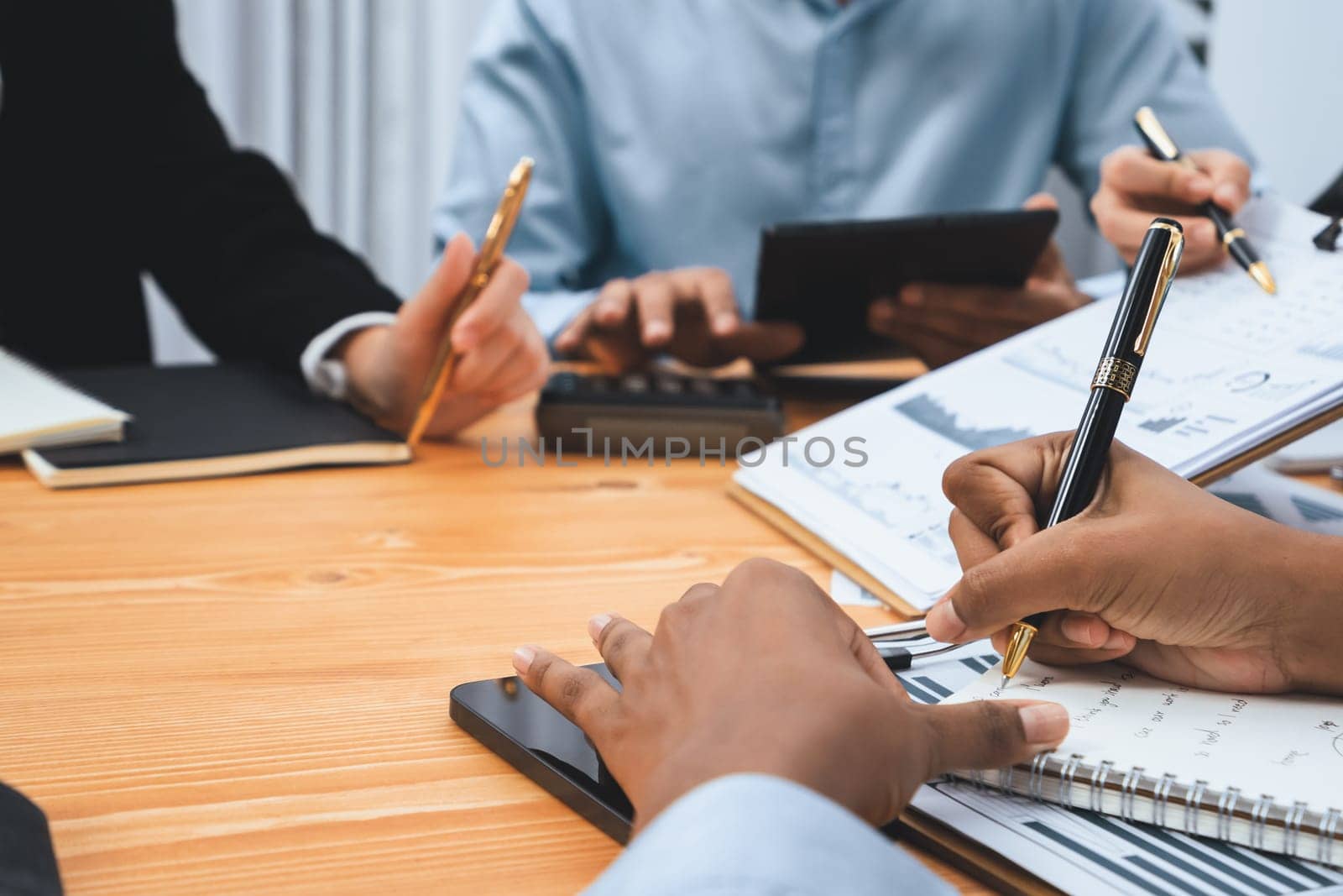 Multiracial analyst team use BI dashboard data to analyze financial report on meeting table. Group of diverse business people utilize data analysis by FIntech for business marketing decision. Concord