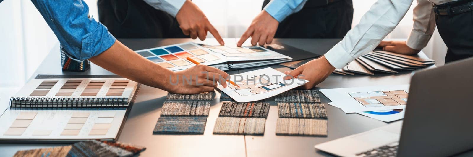 Group of interior designer team in meeting, discussing with engineer on interior design and planning for house project blueprint and model, choosing various mood board materials. Insight