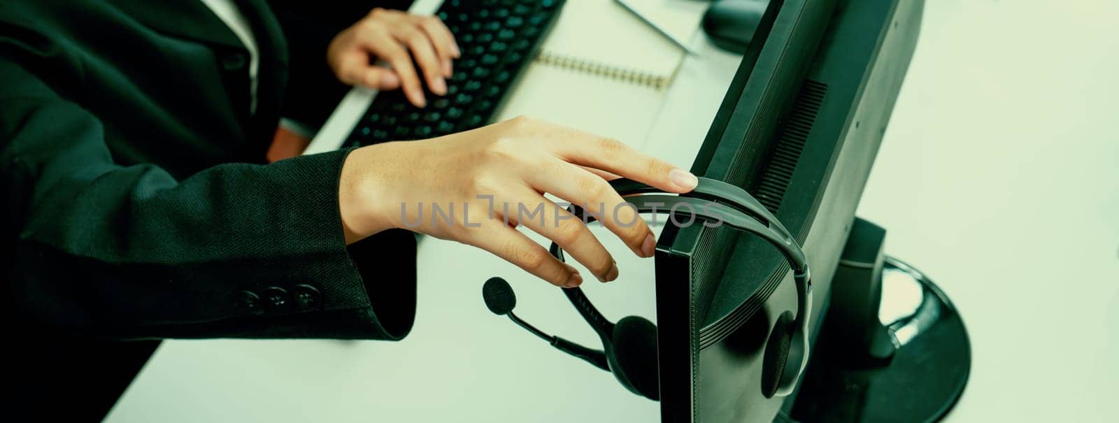 Call center wearing headset working in office for customer support oratory by biancoblue