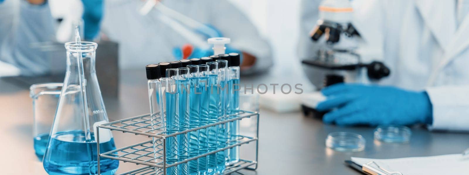 Chemical experiment test tube or medical equipment in laboratory on blurred background of scientist researching vaccine drug or antibiotic. Pharmaceutical and biochemistry lab. Neoteric