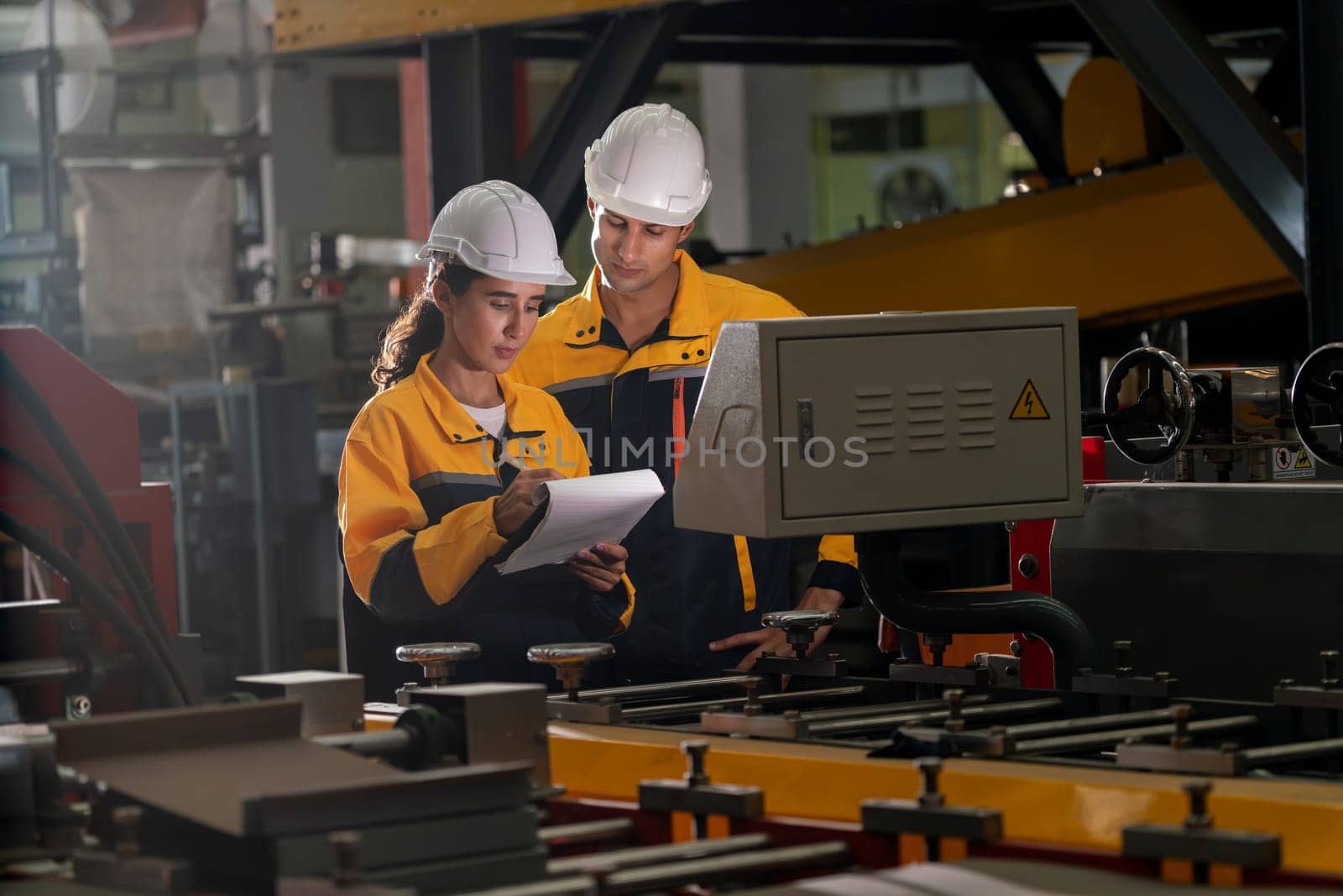 Professional quality control inspector conduct safety inspection on steel machinery and manufacturing process. Factory engineer or operator make optimization in heavy industry facility. Exemplifying