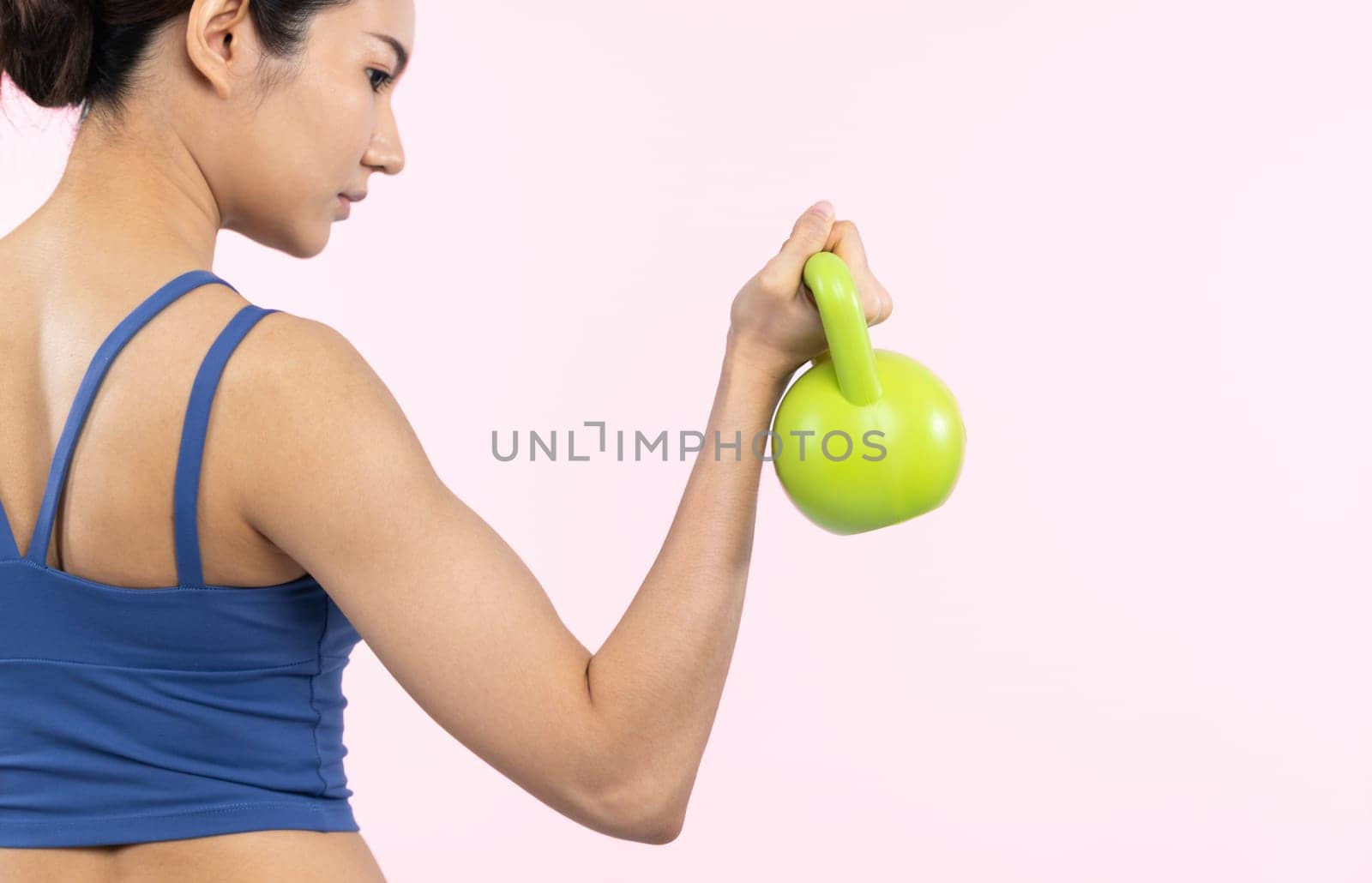 Vigorous energetic woman doing yoga with kettlebell weight exercise. by biancoblue