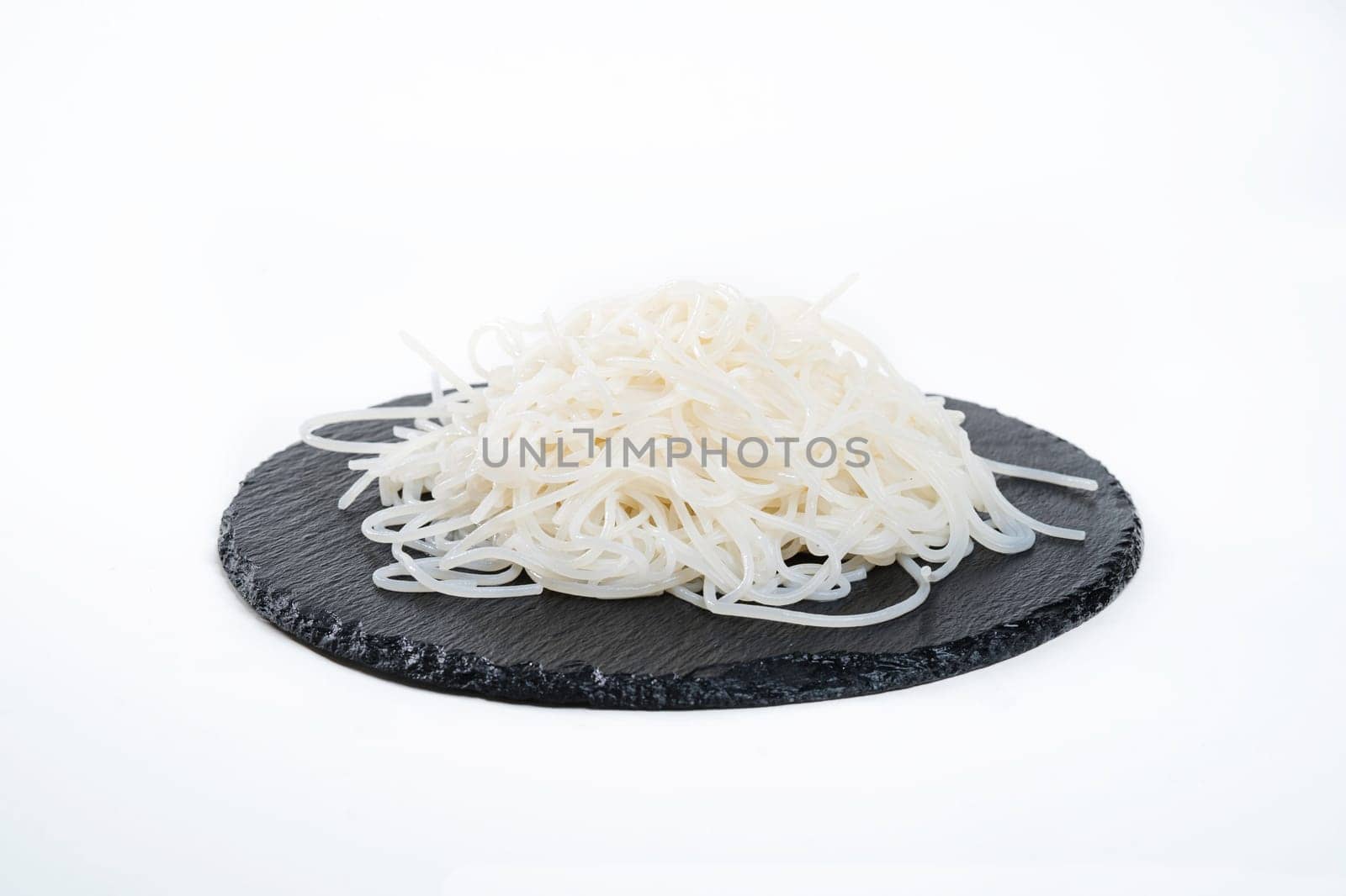 amazing and delicious rice noodles on a black plate. Garnish. View from above. Chinese cuisine, hotpot ingredient by tewolf