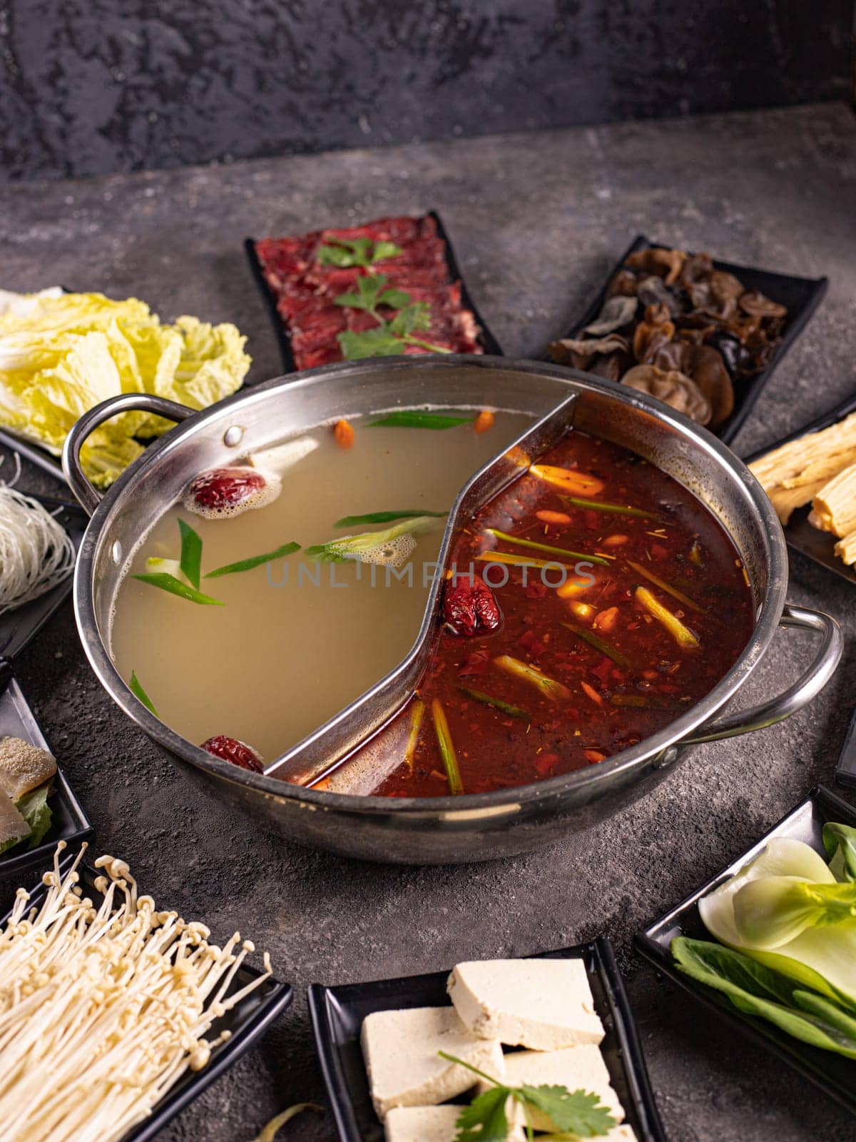 delicious asian bouillon with a lot of extra ingredients. View from above. Chinese cuisine, ingredient for hotpot by tewolf