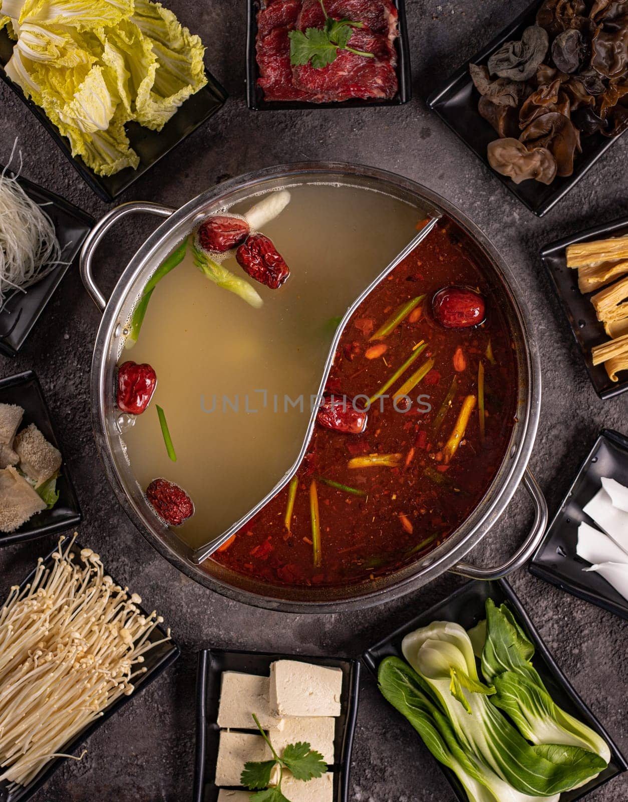 delicious asian bouillon with a lot of extra ingredients. View from above. Chinese cuisine, ingredient for hotpot by tewolf