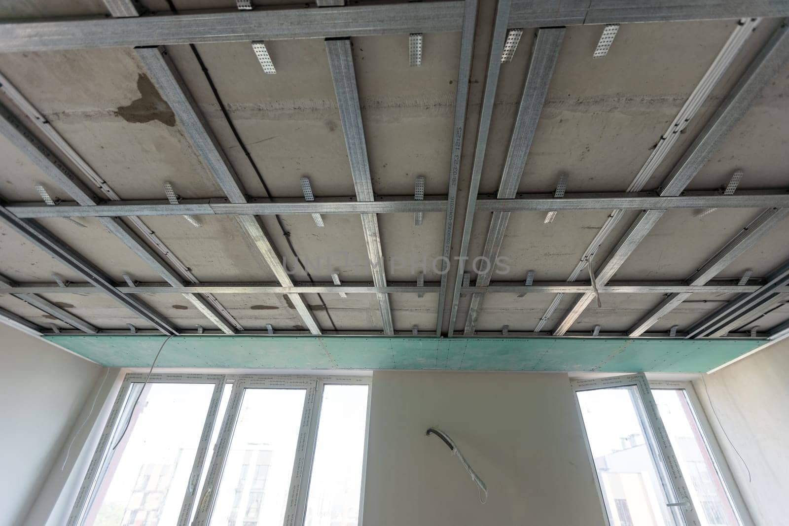 The metal frame of the ceiling, sound insulation, in the process of repairing an apartment. High quality photo