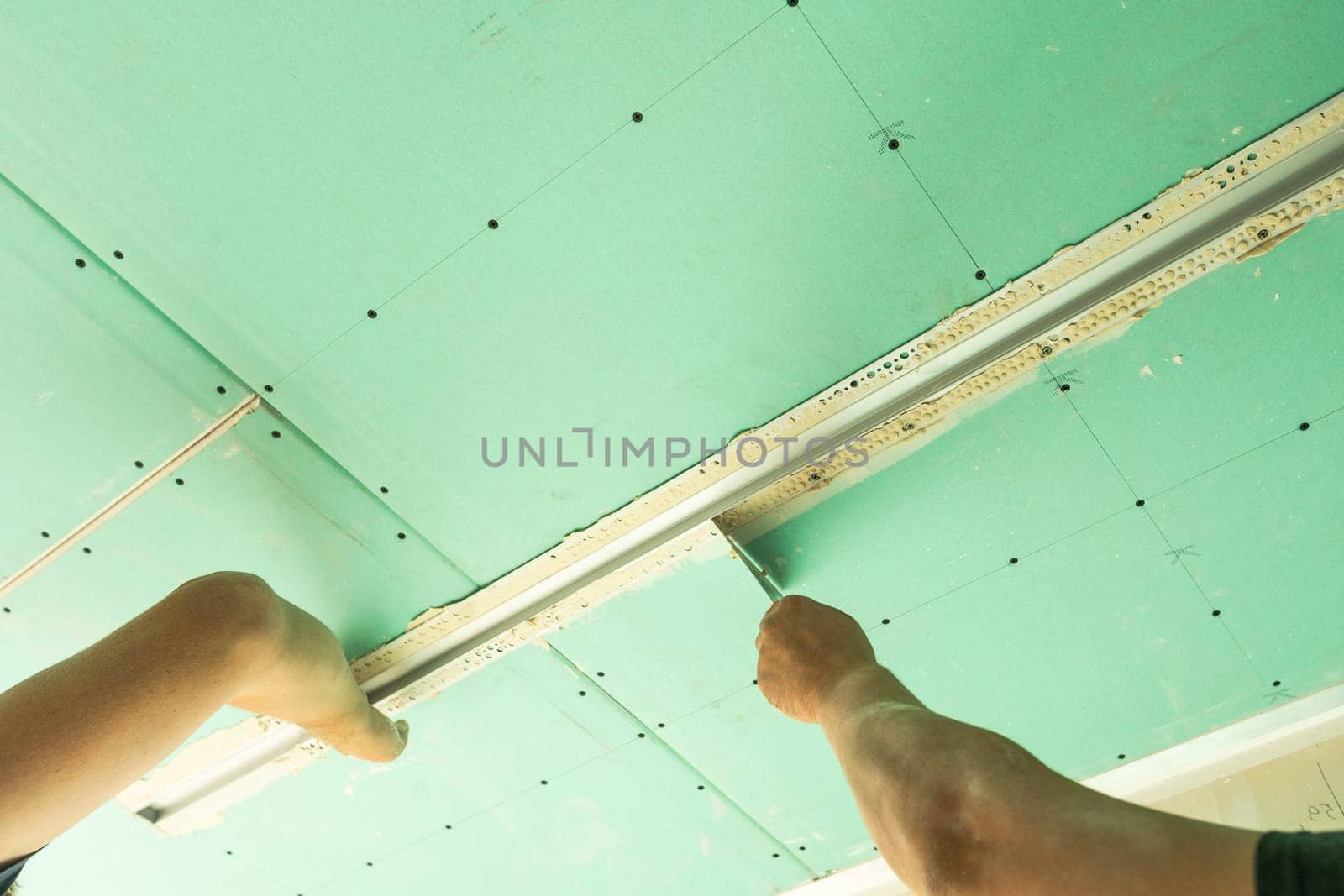 structure of ceiling suspension, installation of gypsum plasterboard and light. High quality photo