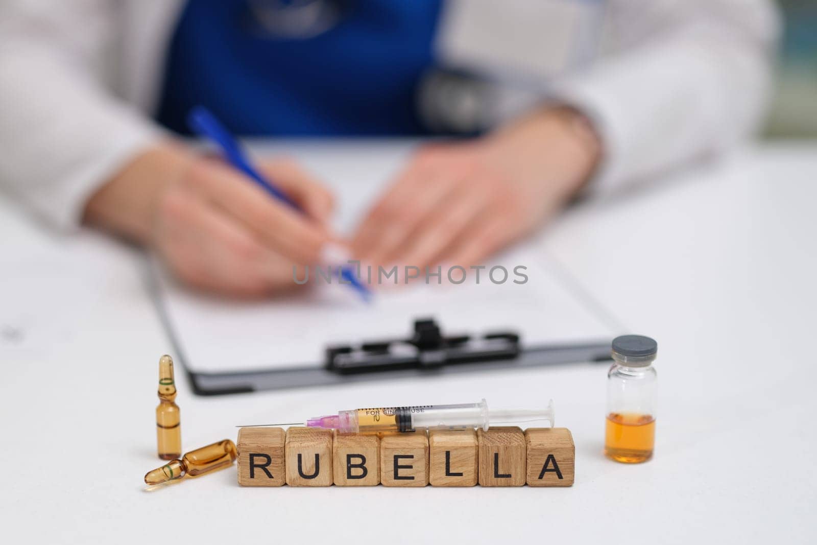 A healthcare professional is meticulously preparing a rubella vaccine while carefully documenting important information
