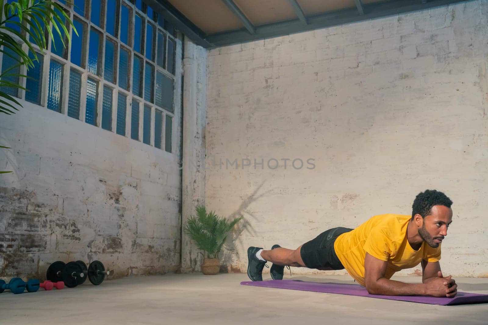 Muscular black man performing plank. Fitness workout concept. High quality photo