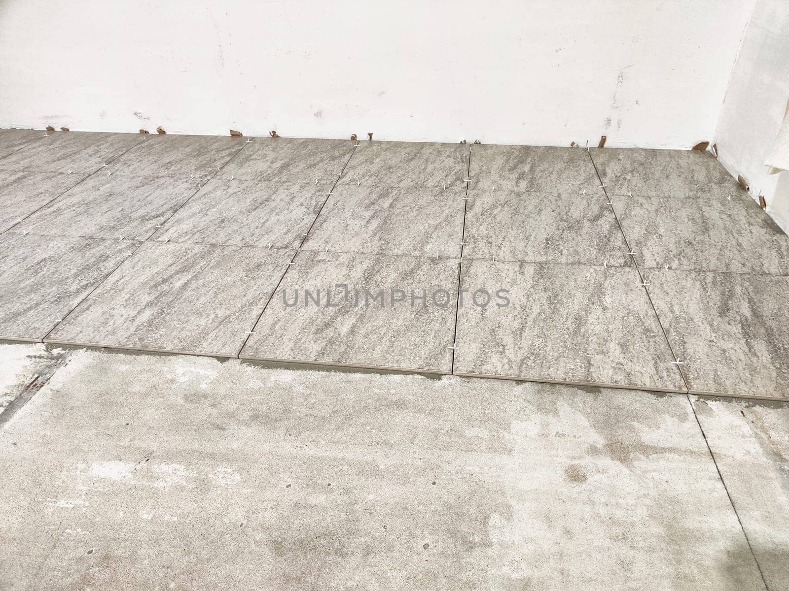 New tiles are laid out in an indoor area, highlighting the progress of a tile repair and installation project for home improvement.