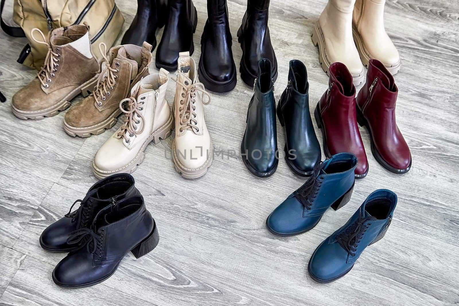 Different styles of trendy shoes are displayed neatly on the floor, showcasing the latest fashion trends in footwear