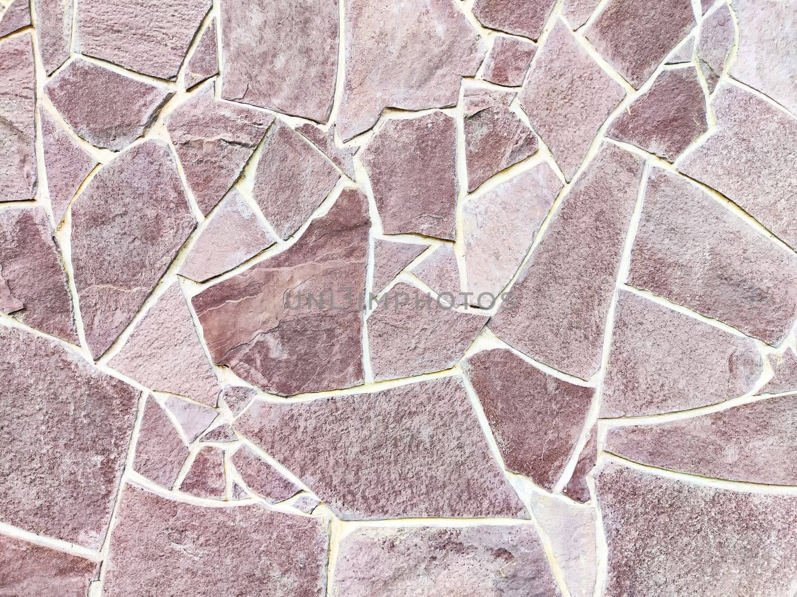 Natural stone with intricate patterns and a soft pink color offers a unique background for various design projects.