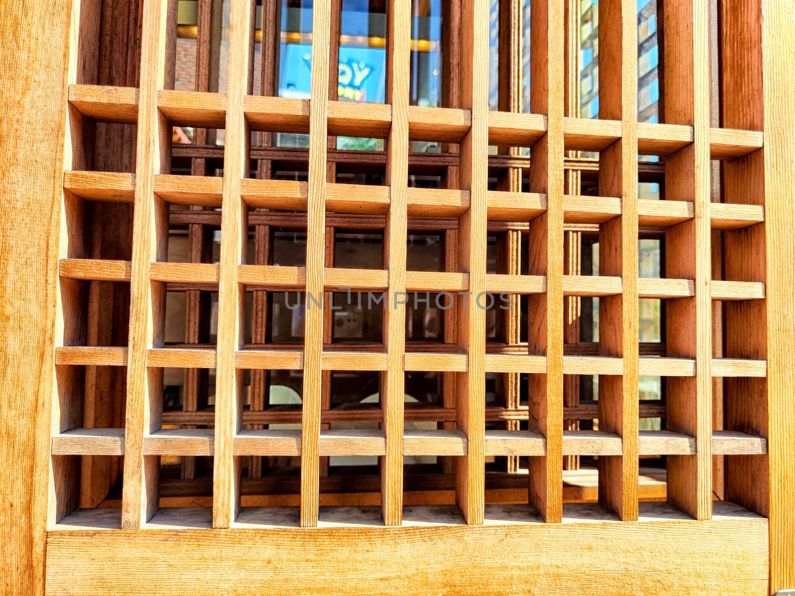 Detailed wooden lattice pattern featuring a space for text, showcasing craftsmanship under natural light, ideal for design projects.