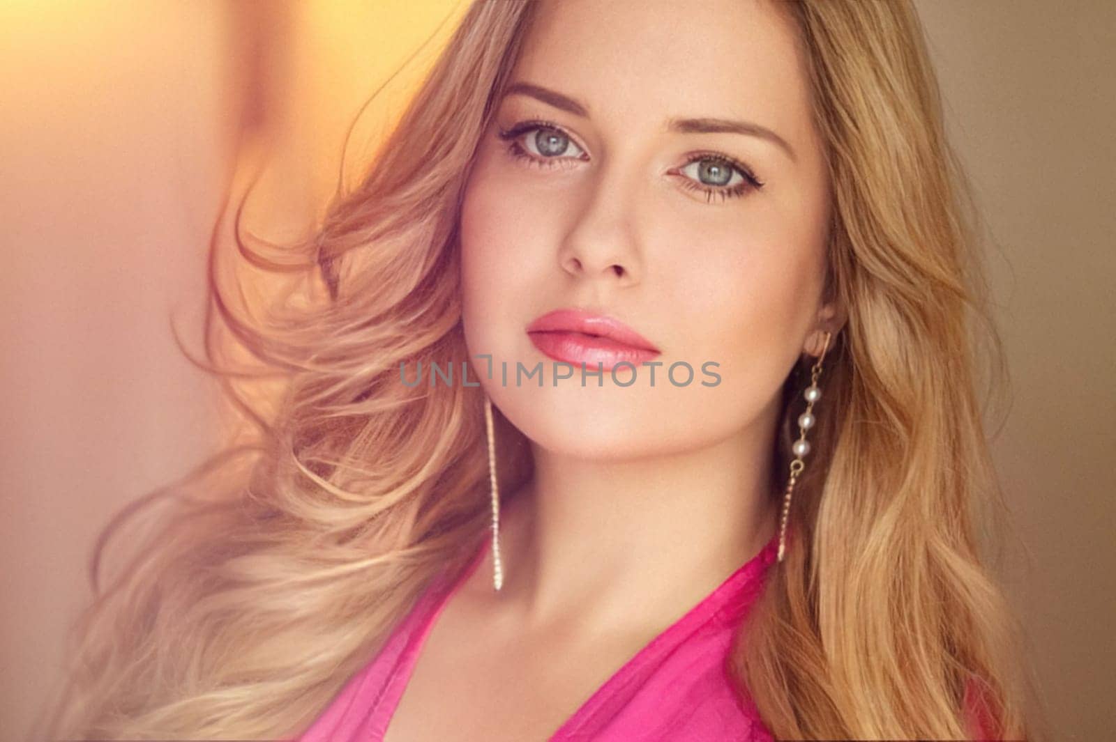 Woman with blue eyes and long, voluminous blonde hair styled in soft curls, wearing pink dress and elegant earrings, dreamy and feminine look idea