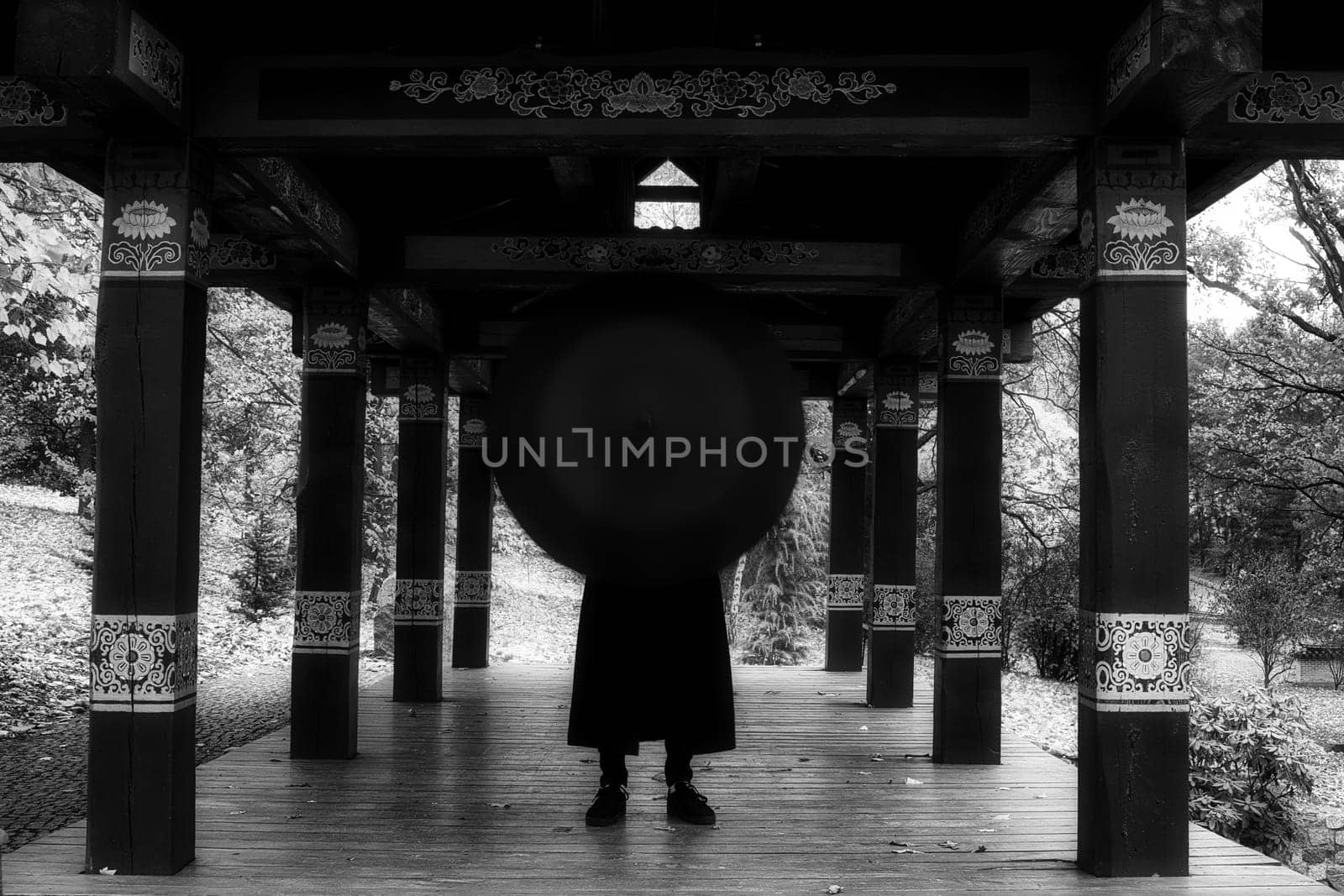 Urban Elegance: The Enigmatic Figure in a Long Coat and Umbrella. High quality photo