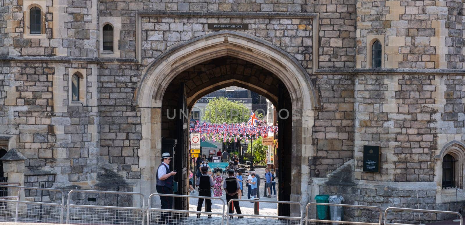 Windsor United Kingdom - August 12 2024; Arch entrance and exit to Windsor Castle with police standing from behind.