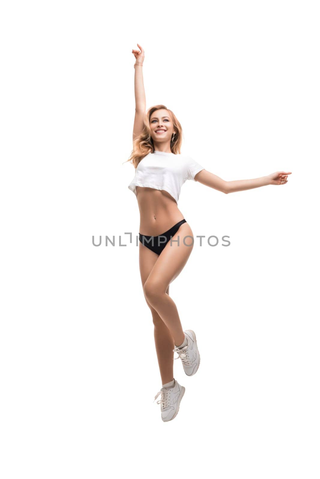 Sexy sporty girl wearing black pants and top isolated full-length shot