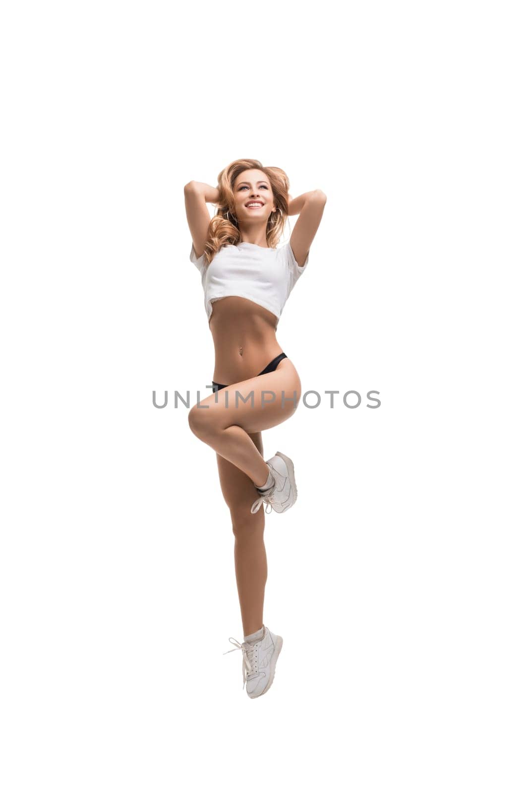 Sexy sporty blonde wearing black pants and top isolated full-length view