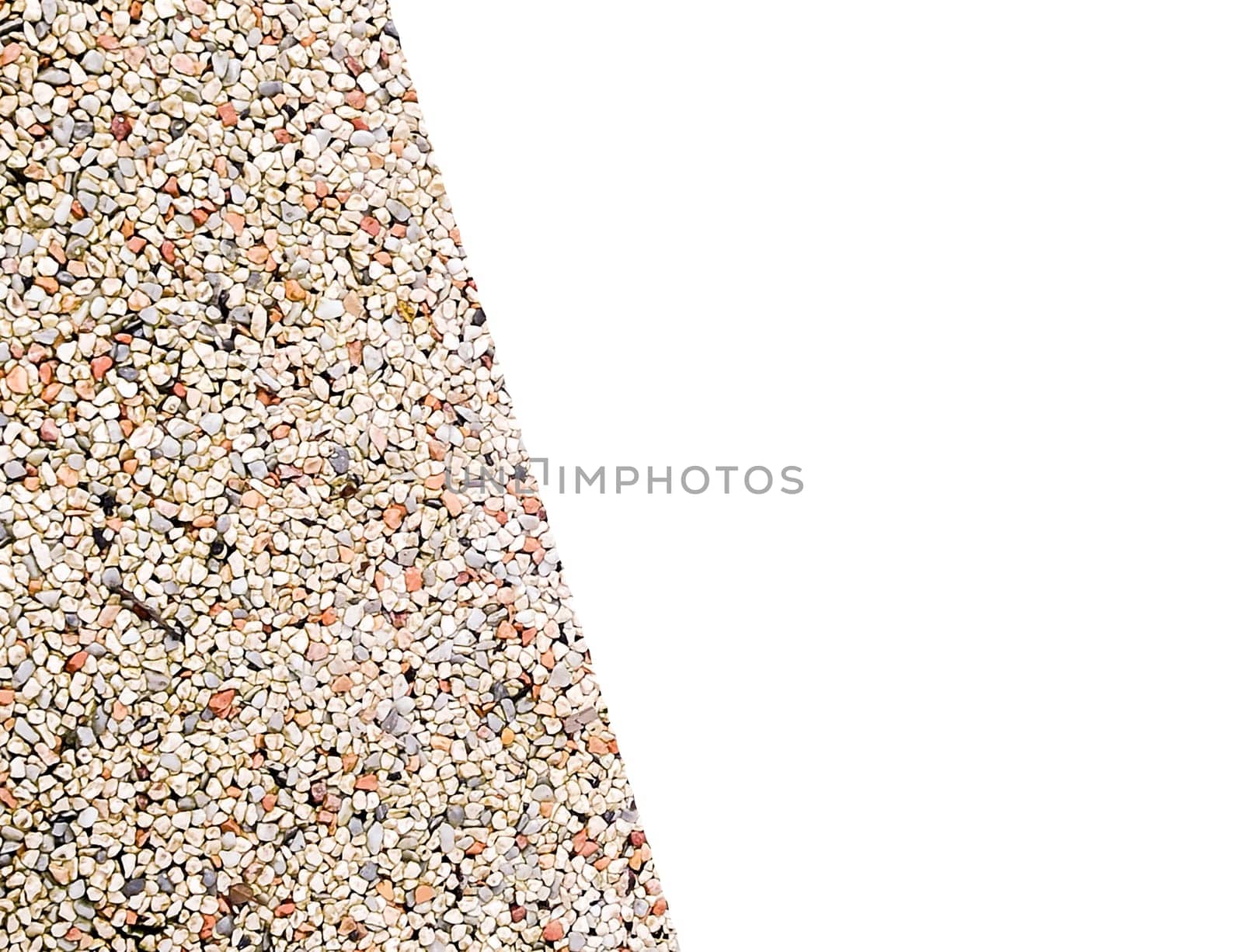 Small, colorful pebbles form an intricate pattern on an outdoor surface, reflecting sunlight and creating a visually appealing texture. The vibrant stones enhance the landscaping.