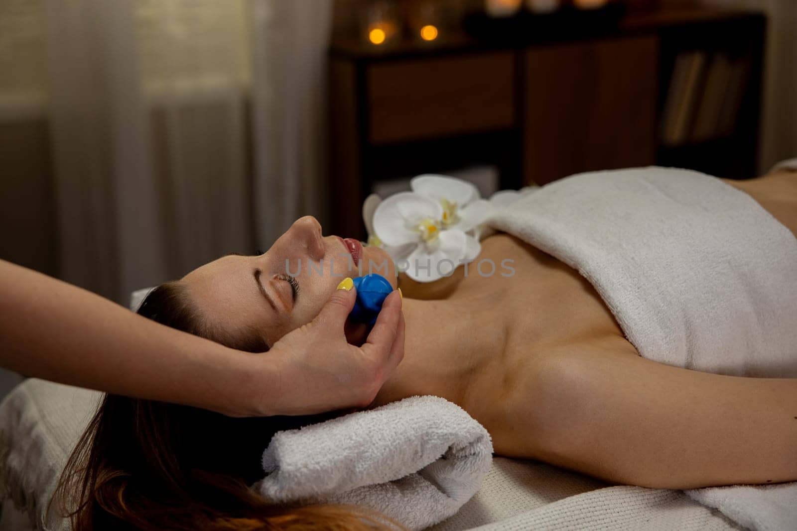 Experience a serene and calming facial treatment that includes soothing massage stones and a tranquil ambiance