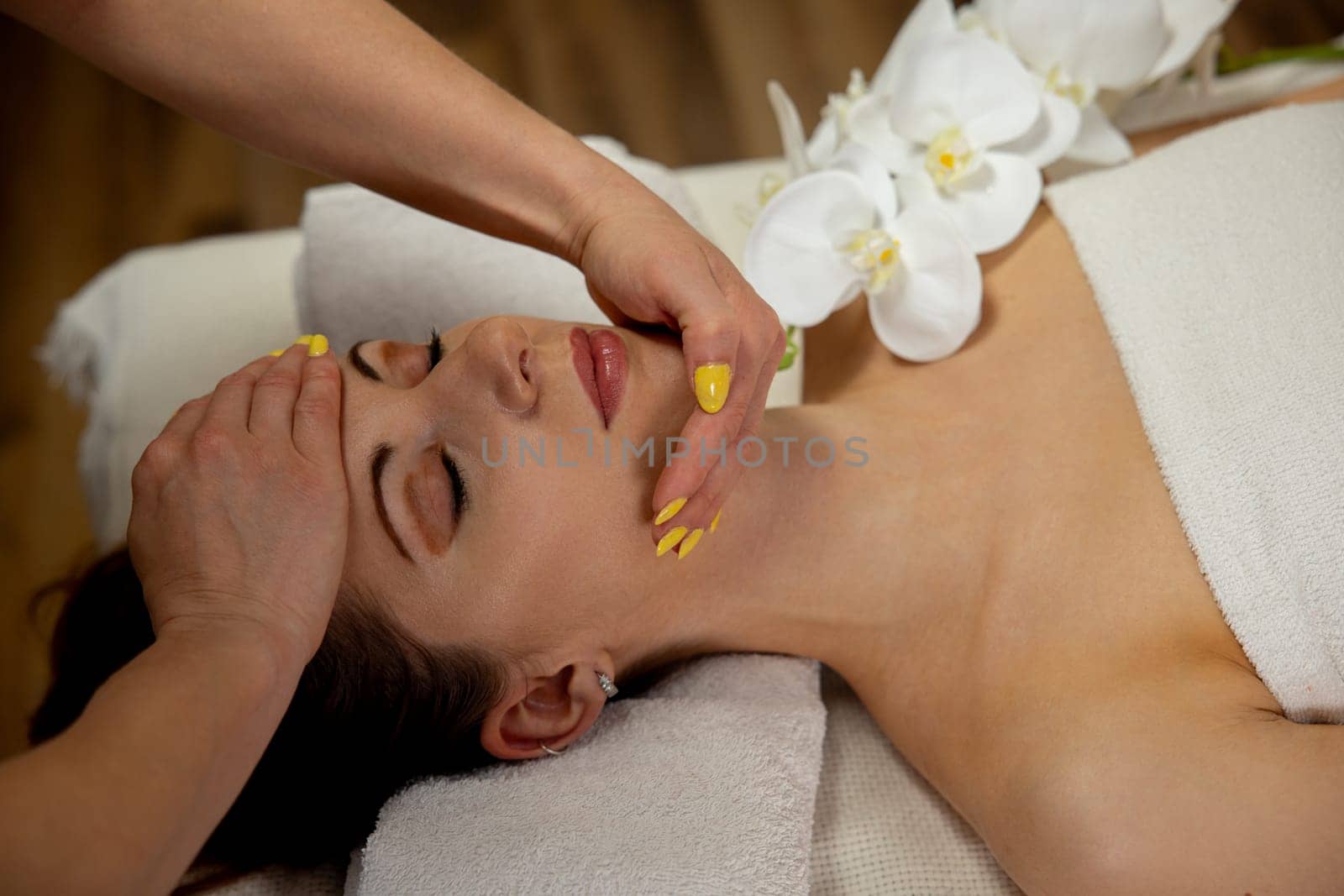Experience tranquility with a soothing spa facial surrounded by serene elements and calming ambiance