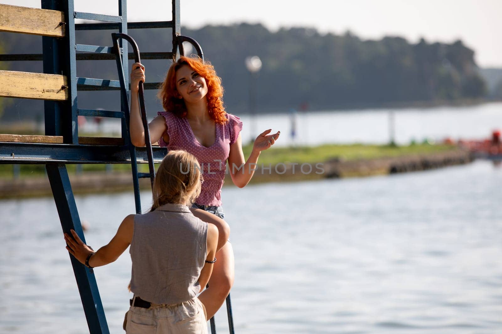 A vibrant scene of young people enjoying a sunny day by the water, capturing the essence of summer leisure.