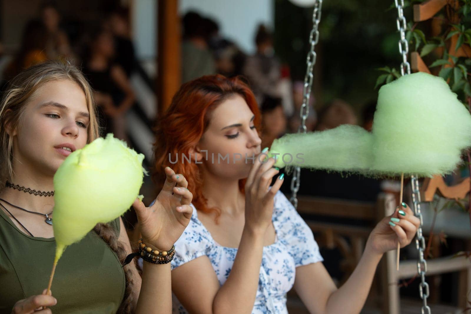 Two close friends joyfully enjoying cotton candy together, depicting a vibrant scene of happiness and youth