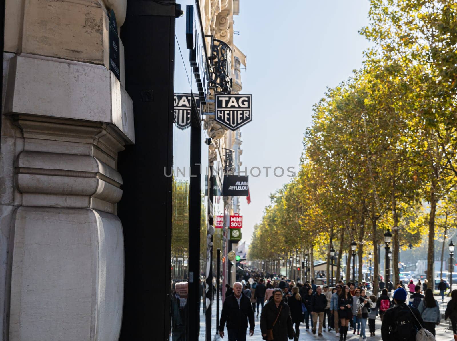 Central street of Paris The Avenue des Champs-Elysees with luxury shops and street life. Paris, France - November 24, 2024